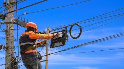 a field worker fixing a power line